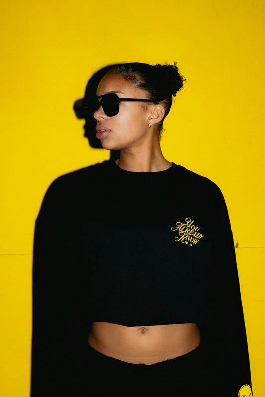 Model wearing Y.A.K long sleeve shirts with yellow scripted logo, premium streetwear apparel, modern fit, minimalist design, lifestyle fashion photography YAK You Already Know