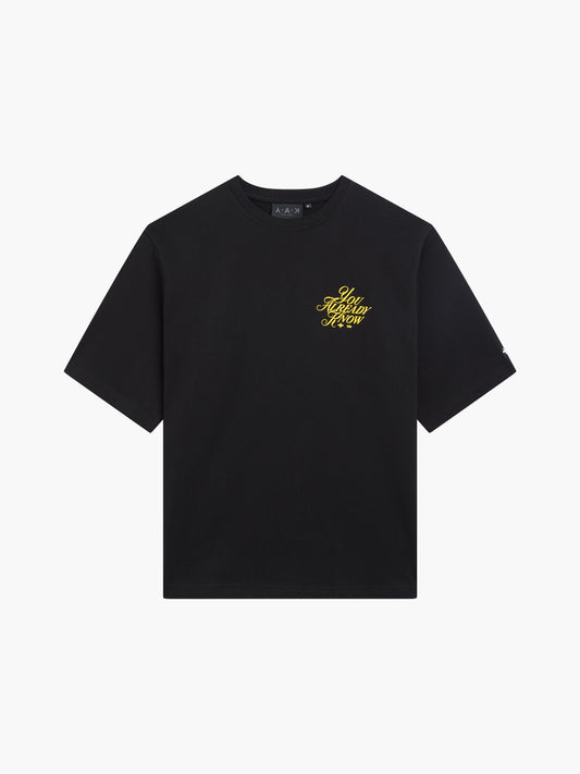 Y.A.K black t-shirt flat lay yellow puff print logo