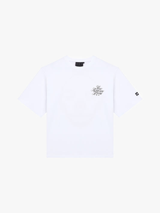 Y.A.K white t-shirt flat lay with black scripted logo, YAK You Already Know
