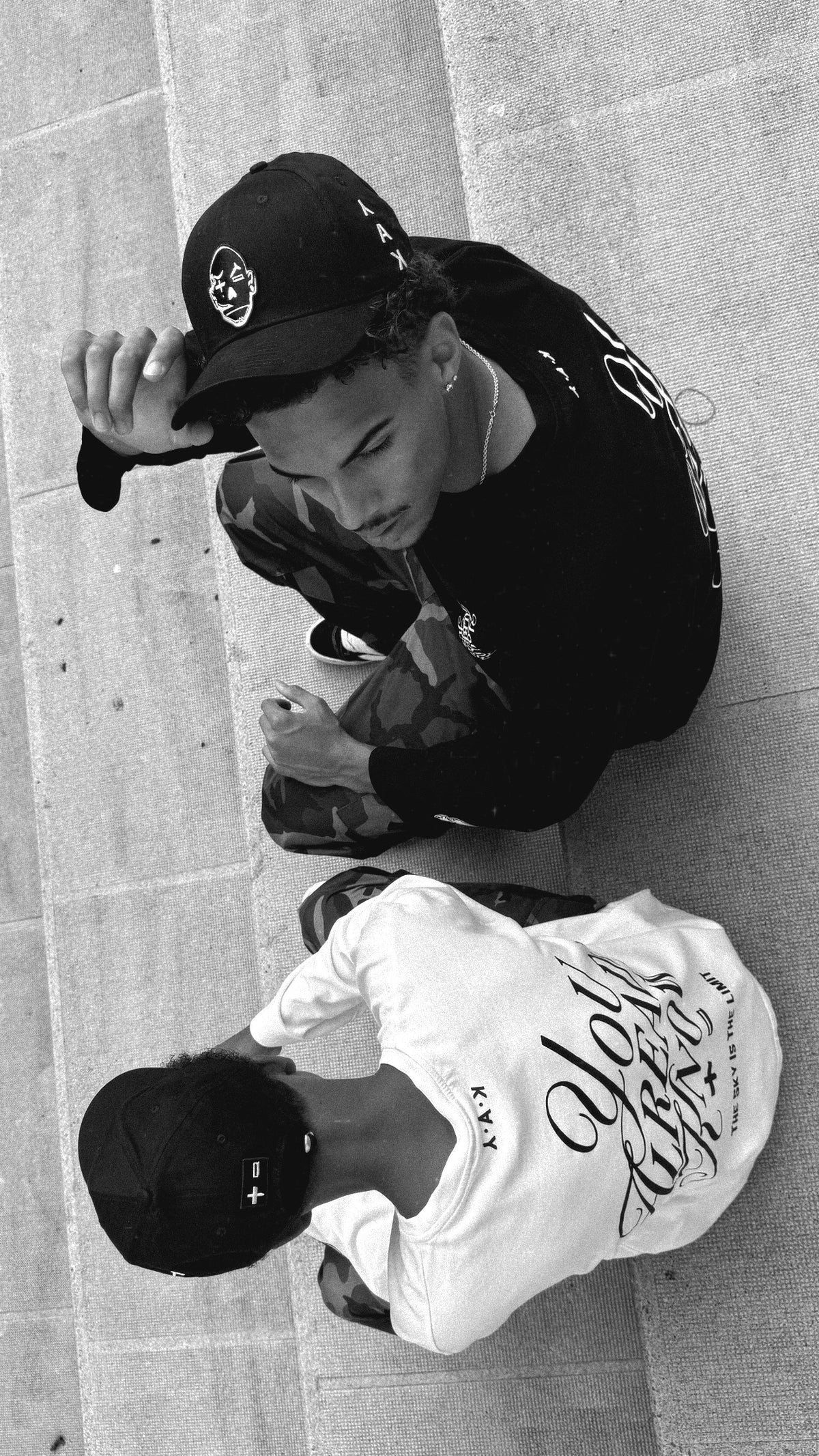 models wearing yak  black and white long sleeve and 6 panel cap