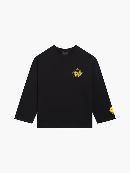 Y.A.K black long sleeve shirt flat lay with yellow scripted logo.